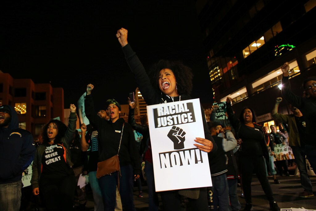 Demonstrators in the "Fight for $15" wage protest are joined by social justice and Black Lives Matter activists at a rally in downtown San Diego, California, U.S., November 29, 2016. REUTERS/Mike Blake - RC1BE23C5B50