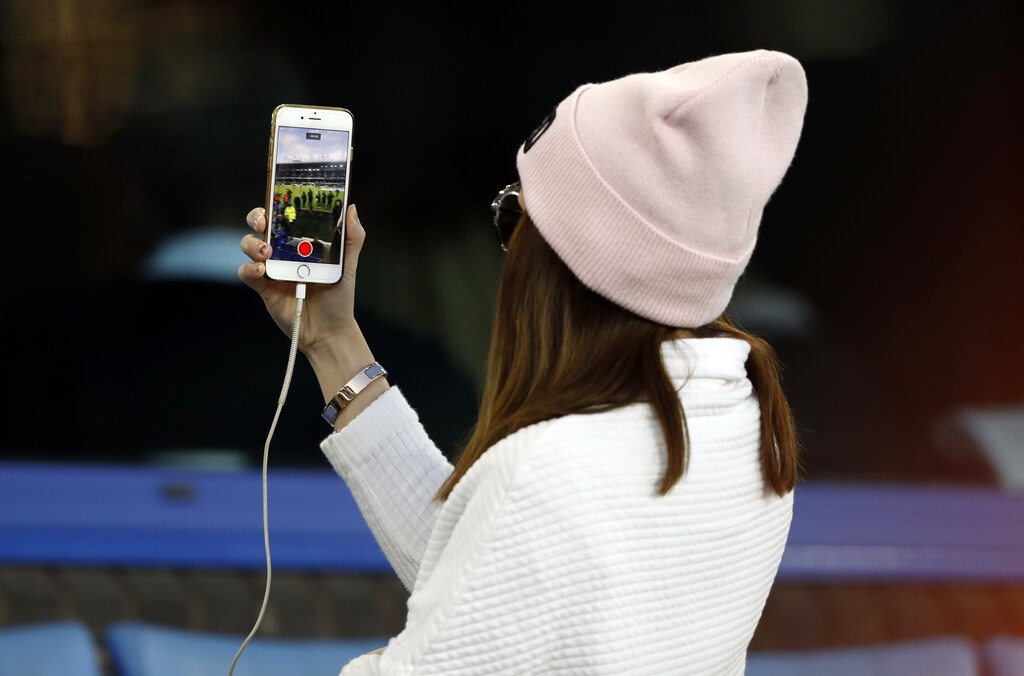 Football Soccer Britain - Everton v Manchester United - Premier League - Goodison Park - 16/17 - 4/12/16 Fan records on her phone Action Images via Reuters / Carl Recine EDITORIAL USE ONLY. No use with unauthorized audio, video, data, fixture lists, club/league logos or "live" services. Online in-match use limited to 45 images, no video emulation. No use in betting, games or single club/league/player publications. Please contact your account representative for further details - RTSV4H9