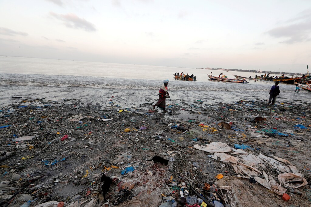 A woman is pictured at a fishermen port on the outskirts of Dakar, Senegal July 26, 2019. Picture taken July 26, 2019. REUTERS/Zohra Bensemra TPX IMAGES OF THE DAY - RC139E09E620
