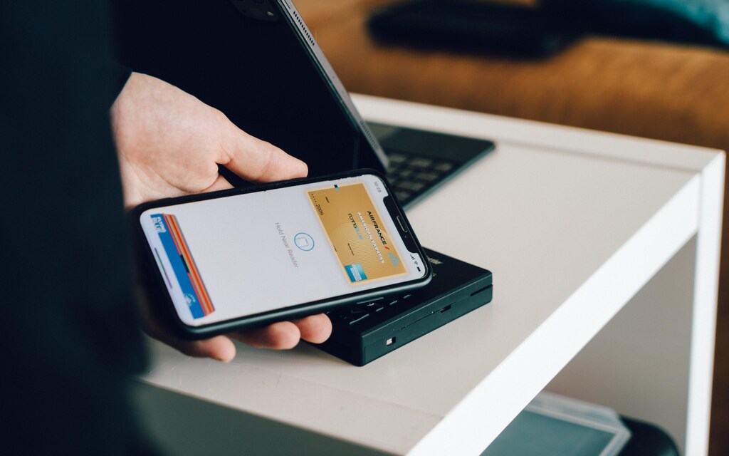 A person purchasing an item using digital device.