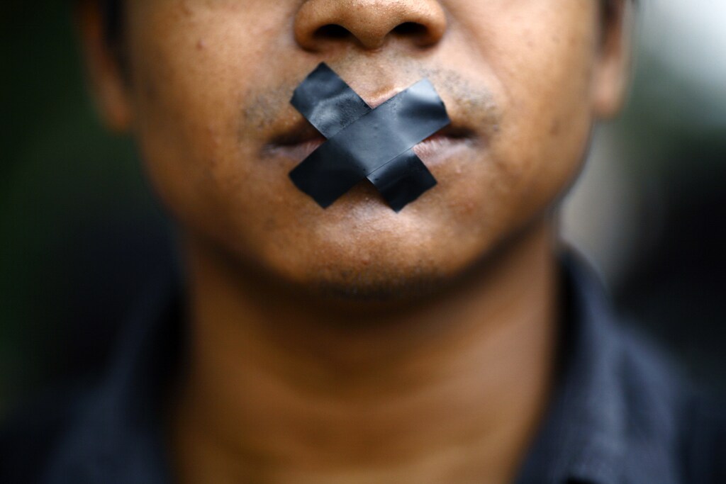 An artist, with his mouth taped, takes part in a protest demanding the safety of artist Manish Harijan and his freedom of expression, near the Kathmandu District Administration Office (DAO) in Kathmandu September 13, 2012. According to the local media, the protest was organized by Nepalese artists because of the death threat received by Harijan for creating and exhibiting paintings depicting Hindu gods blended into images of western superheroes like Ghost Rider and Superman. The Siddhartha Art Gallery, where the paintings are currently being exhibited at, has been sealed by the DAO. REUTERS/Navesh Chitrakar (NEPAL - Tags: RELIGION SOCIETY CIVIL UNREST) - GM1E89D1CDP01