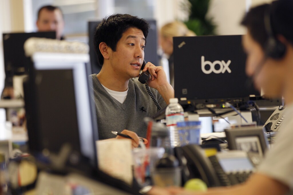 Employees work at the headquarters of Box.net, an online file sharing and Cloud content management service for enterprise companies, in Los Altos, California February 5, 2013. Startups often thrive on a lack of rules and boundaries. But experts say that as they make the transition from a handful of people in a room to sizeable businesses, the hazards of operating without manual - including lawsuits, reputational hits, and waning employee morale - grow exponentially. Picture taken February 5, 2013. To match story STARTUPS-SQUARE/ REUTERS/Robert Galbraith (UNITED STATES - Tags: SCIENCE TECHNOLOGY BUSINESS) - RTR3DMK7
