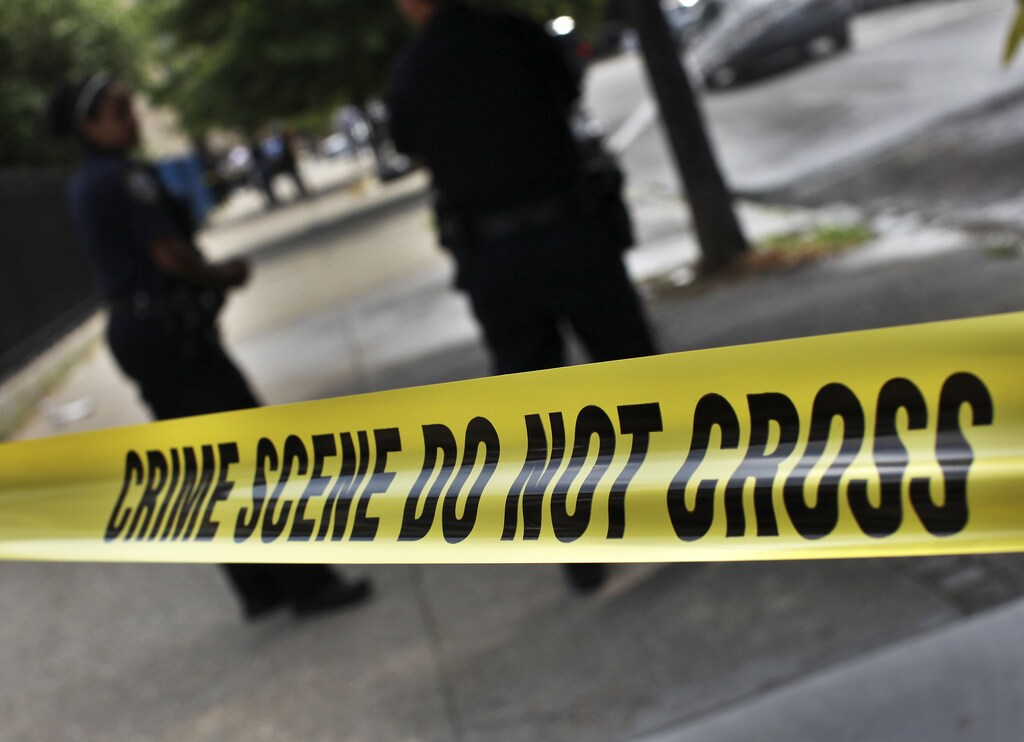 NYPD crime scene tape is seen at the site of a shooting at the corner of Marcus Garvey Blvd. and Pulaski Street in the Brooklyn borough of New York July 9, 2012. A wave of violence saw 7 killed and at least 21 injured by stabbings or shootings throughout the city over the past weekend.
