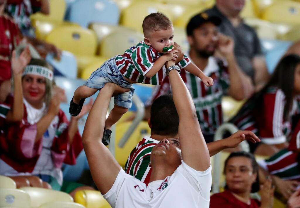 Soccer Football - Brasileiro Championship - Fluminense v Sport Recife - Maracana Stadium, Rio de Janeiro, Brazil - November 11, 2018 Fluminense fan holds a baby REUTERS/Pilar Olivares - RC15AC851160