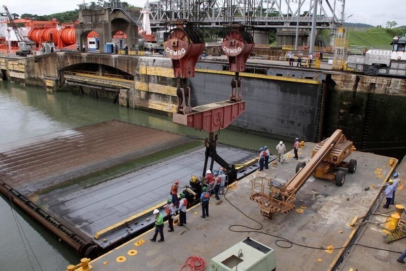 Employees work in a dry chamber of the Miraflores locks during its periodical maintenance at the Panama Canal in Panama City, Panama, August 1, 2017.