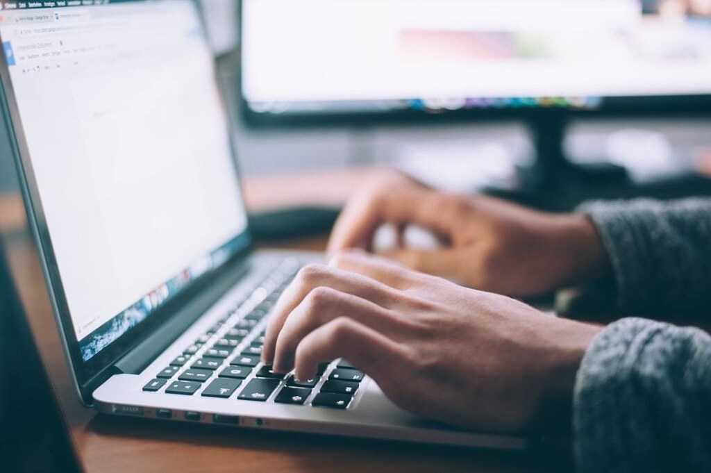 image of person typing on laptop