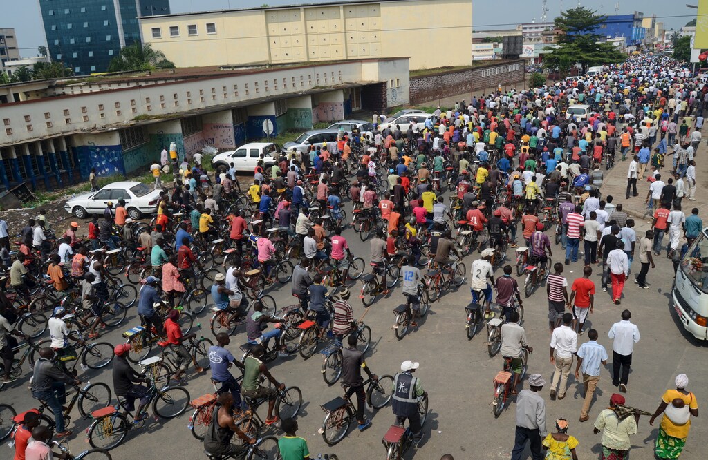 Residents cycle as they participate in a demonstration against the Rwandan government in Burundi's capital Bujumbura cities growth demographics change increase size Africa populations malawi Lilongwe Ouagadougou Burkina Faso Uige Angola Bobo-Dioulasso Burkina Faso Dar es Salaam Tanzania Tete Mozambique Niamey Niger Bunia Congo Gwagwalada Nigeria Mwanza Tanzania Songea Tanzania Kabinda Congo Kampala Uganda Zinder Niger Bujumbura Burundi cities smart urban urbanization development growth growing inclsuive inclusivity poverty tech technology science data electricity electric power fourth industrial revolution 4ir progress advancement power new revolutionary robot robotics ai artificial intelligence machine learning