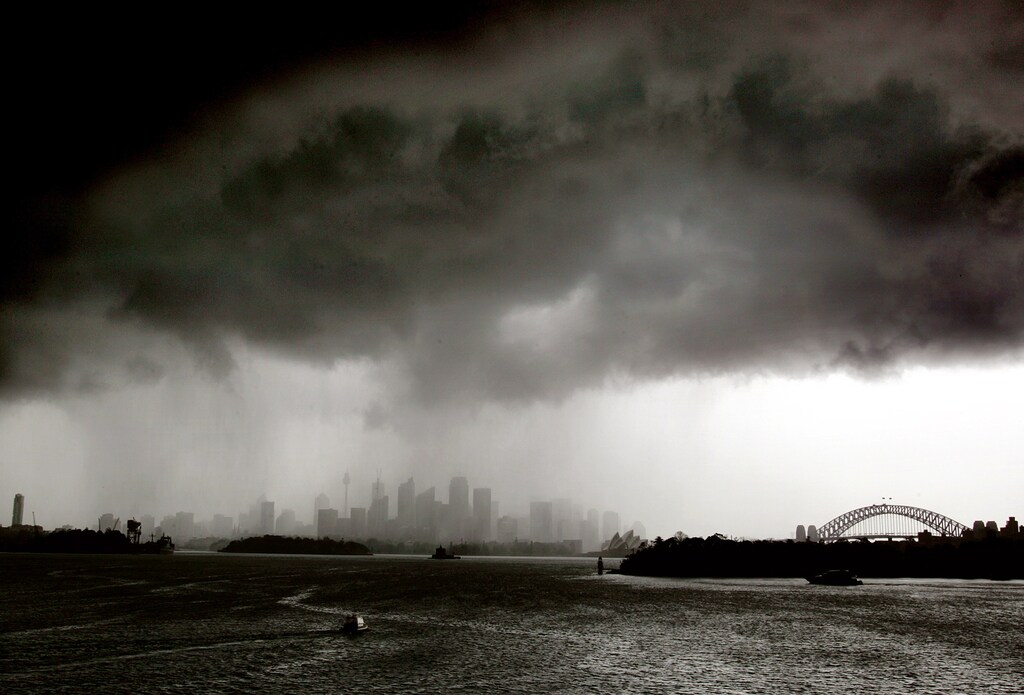Boats sail on Sydney harbour as a severe storm hits the city December 13, 2004. Severe weather closed Sydney's airport and caused property damage after storms hit the city mid-afternoon producing large hailstones and causing flooding. NO RIGHTS CLEARANCES OR PERMISSIONS ARE REQUIRED FOR THIS IMAGE. REUTERS/David Gray DG/CP - RP5DRHYTGYAB
