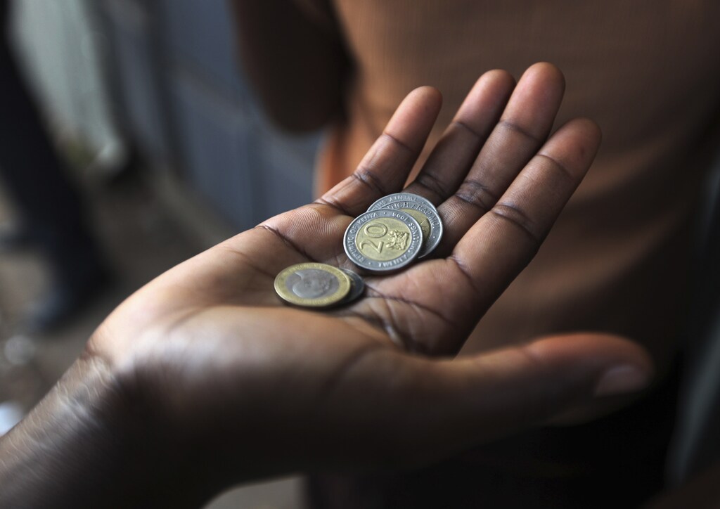 A customer has his money ready at a store in the sprawling Kibera slums in Kenya's capital Nairobi April 23, 2010. REUTERS/Noor Khamis (KENYA - Tags: SOCIETY BUSINESS) - GM1E65C0S6W01