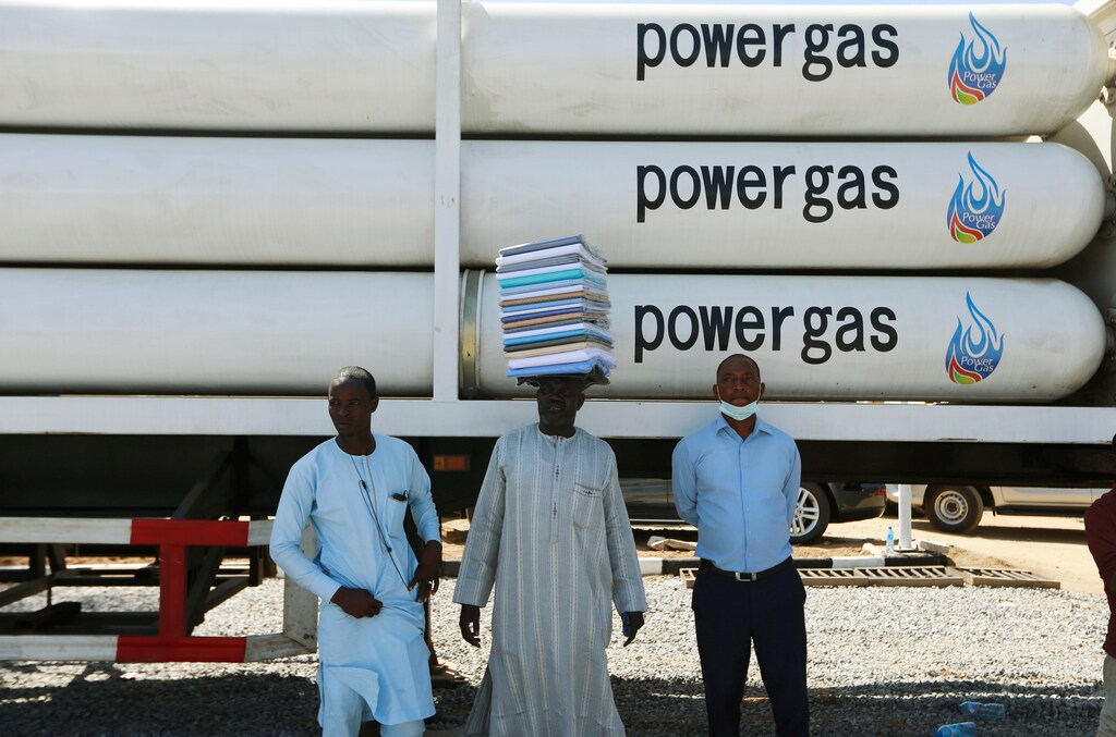 Men stand near a gas truck during the unveiling of the National Gas Expansion Programme, in Abuja, Nigeria.