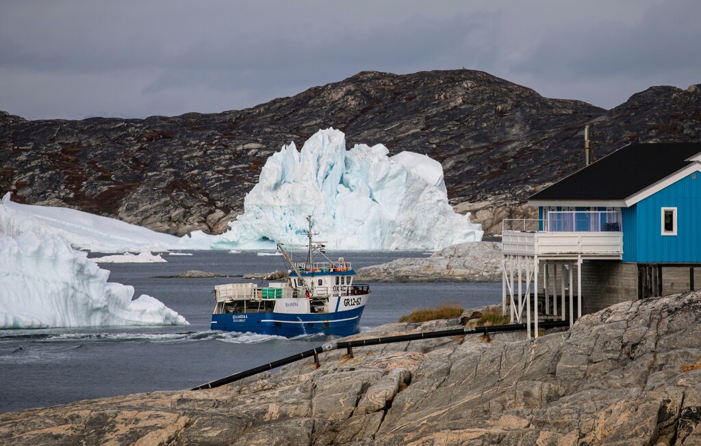 A fisher boat sails back to Ilulissat, Greenland, as climate change threatens the Arctic. September 14, 2021.