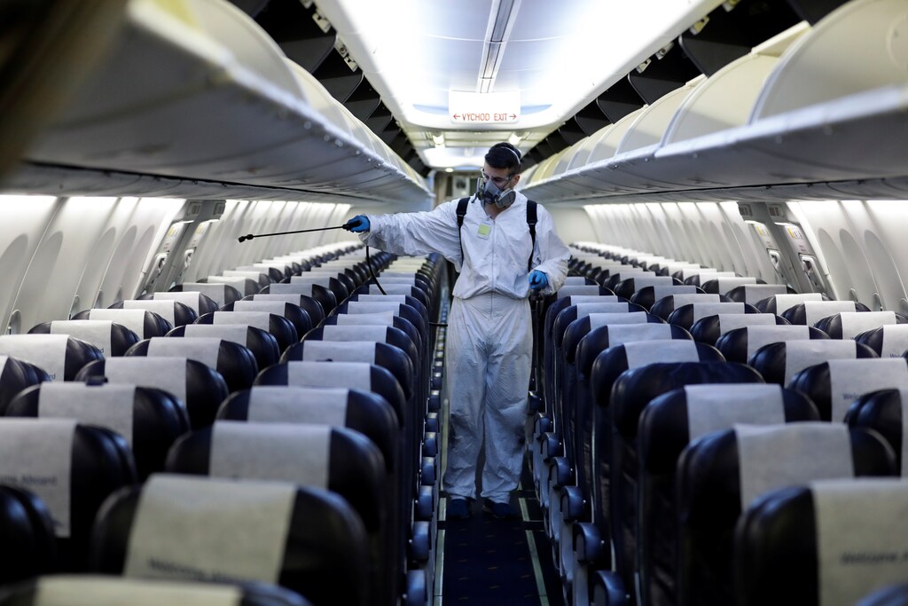 A worker in a protective suit disinfects a passenger plane of Smartwings airline at Vaclav Havel Airport due to the coronavirus disease (COVID-19) concerns in Prague, Czech Republic, May 21, 2020. REUTERS/David W Cerny - RC25TG9U8ZK3