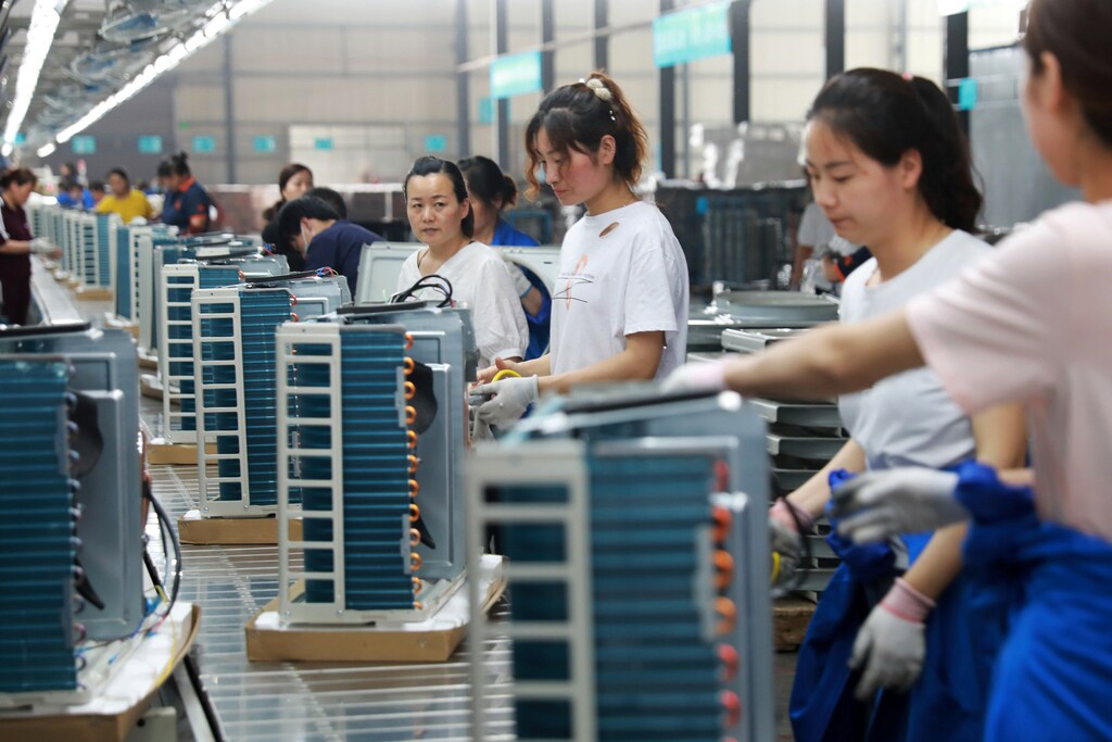 Women work on a production line manufacturing air conditioners, at a factory of an electrical engineering company in Huaibei, Anhui province, China May 30, 2019. REUTERS/Stringer ATTENTION EDITORS - THIS IMAGE WAS PROVIDED BY A THIRD PARTY. CHINA OUT.