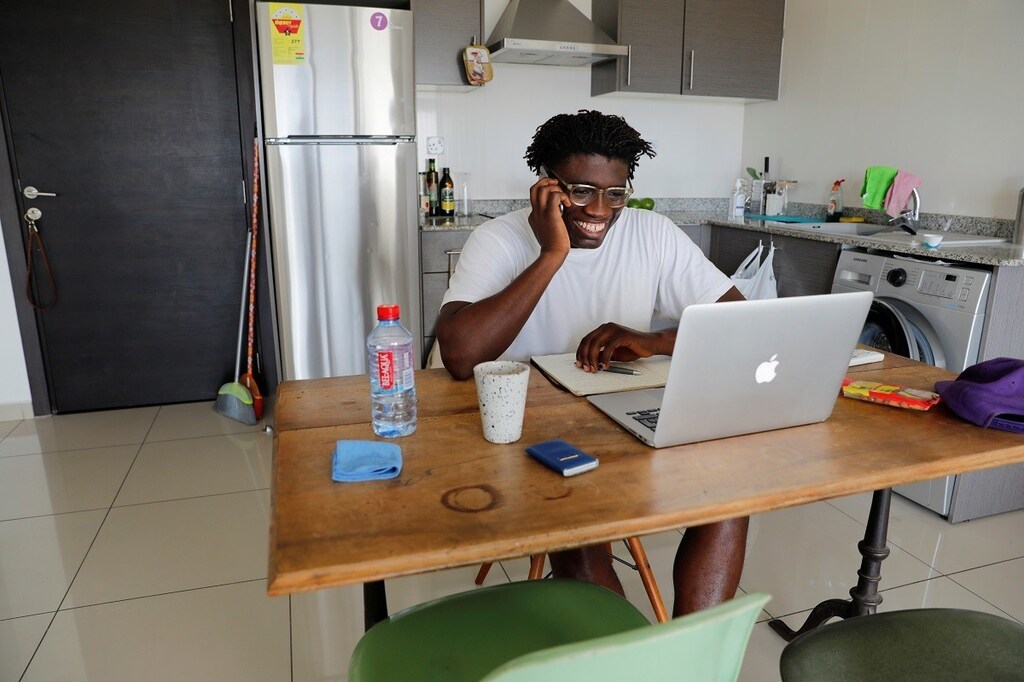 Jeff Provencal, 33, works from home after being released from a 14-day quarantine, as Ghana enforces a partial lockdown in the cities of Accra and Kumasi to slow the spread of the coronavirus disease (COVID-19), Accra, Ghana April 6, 2020. REUTERS/Francis Kokoroko - RC24ZF91G5SA
