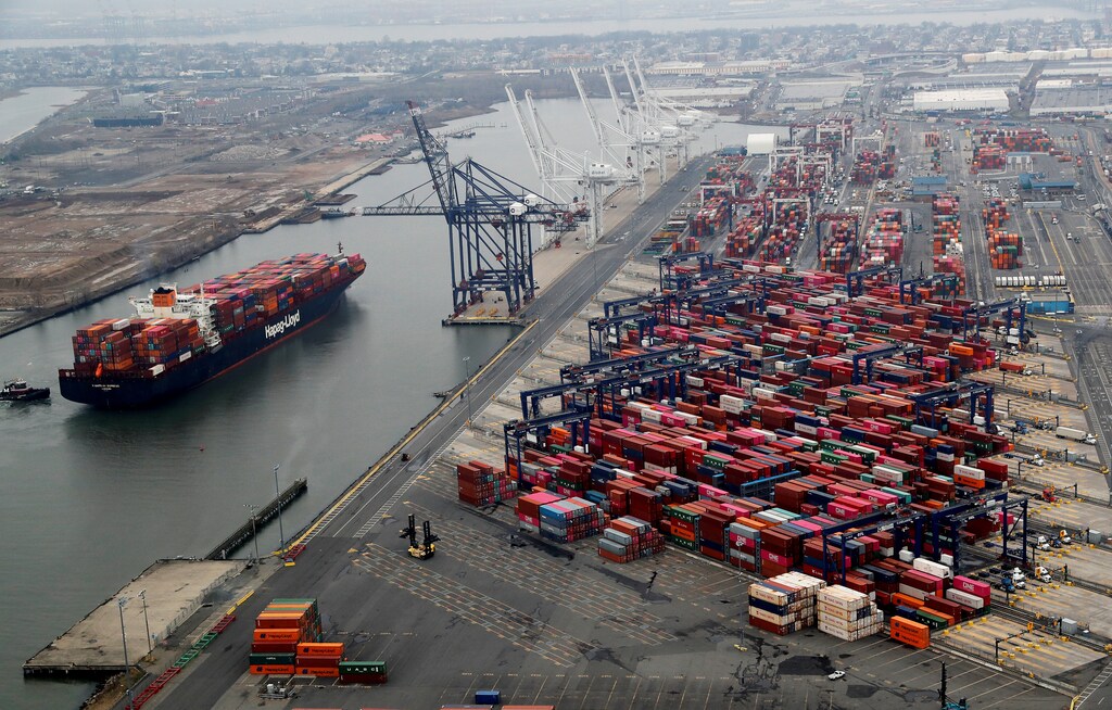 A container ship is seen as hundreds of shipping containers are seen stacked at a pier at the Port of New York and New Jersey in Elizabeth, New Jersey, U.S., March 30, 2020. REUTERS/Mike Segar - RC2HUF9Y67Y6