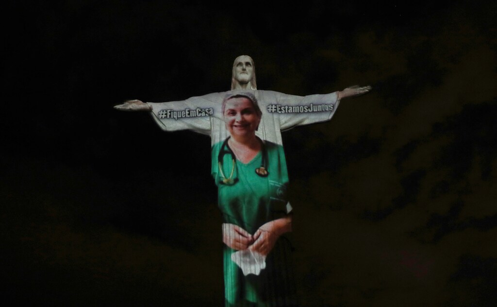 The statue of Christ the Redeemer is lit up with the image of a medical worker during an Easter Sunday event, amid the coronavirus disease (COVID-19) outbreak, in Rio de Janeiro, Brazil April 12, 2020. REUTERS/Ricardo Moraes - RC293G9K7FRI