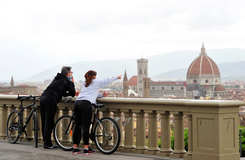 People enjoy the view of Florence from Piazzale Michelangelo during the lockdown, ahead of Italy's gradual lifting of restrictions which begins from May 4, due to the spread of the coronavirus disease (COVID-19), in Florence, Italy, May 1, 2020. REUTERS/Jennifer Lorenzini - RC2NFG9NL8S7