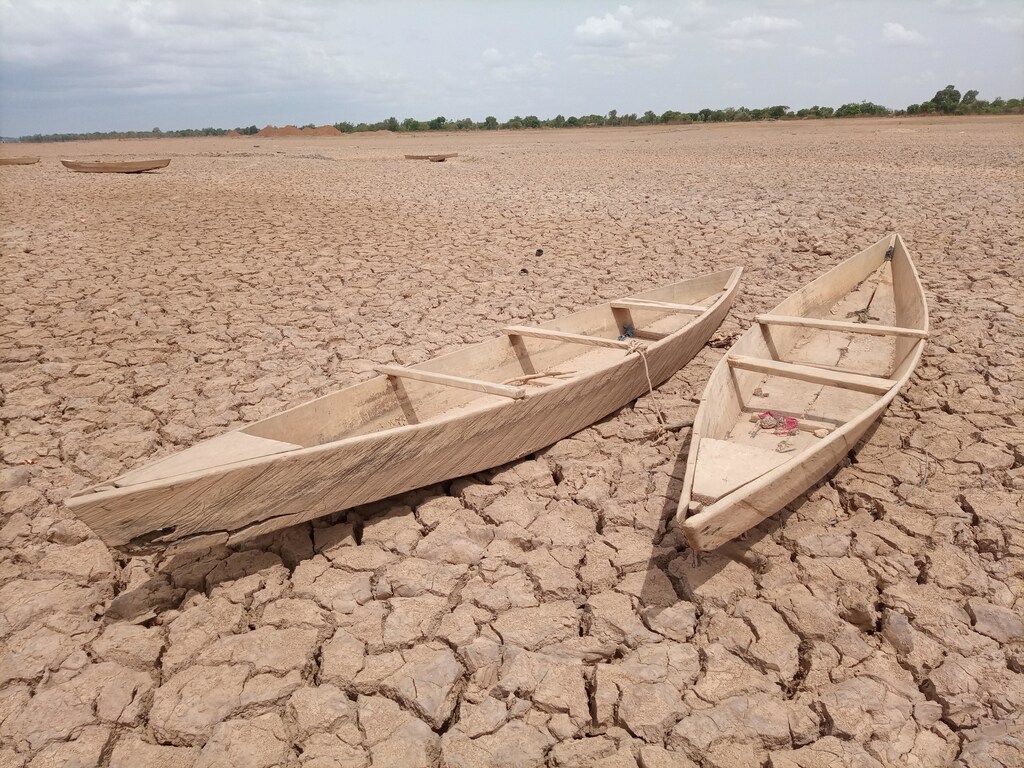 This image shows two boats marooned on a drought-stricken river bed where no water flows, illustrating how the hydrogen economy must show that it won't impact water security