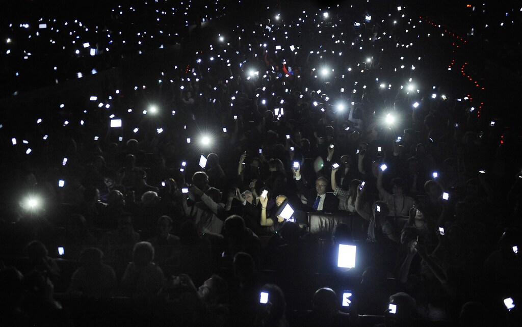 Delegates hold up mobile devices during the Bilbao Web Summit in the Palacio Euskalduna May 17, 2011. Event organizer Xabier Uribe-Etxebarria, CEO of the Anboto Group, asked visitors to illuminate the auditorium with their mobile phones and tablet computers as a "present" to World Wide Web founder Tim Berners-Lee, a guest speaker at the two day event which includes a meeting of the W3C Advisory Committee. REUTERS/Vincent West (SPAIN - Tags: SCI TECH BUSINESS) - GM1E75I0FBT01