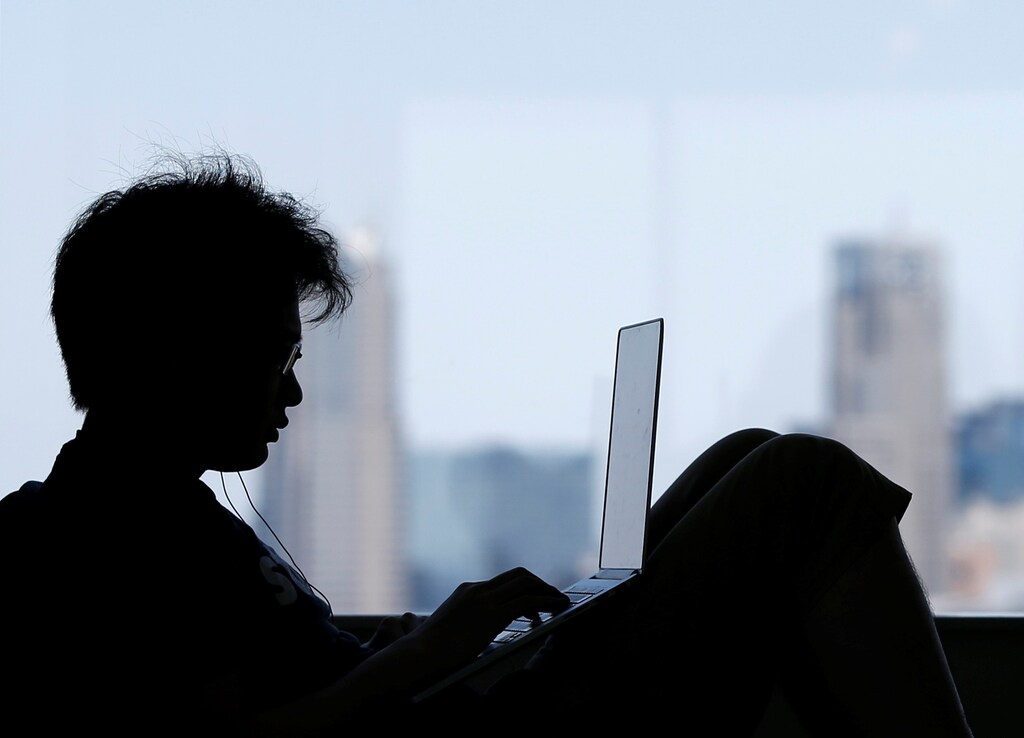 A man uses a laptop at a rest area in the Line Corp's headquarters in Tokyo, Japan June 2, 2016. REUTERS/Toru Hanai - RTX2F941