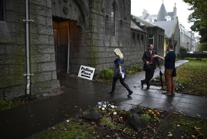 A voter arrives to cast her ballot at the Queen's Cross parish church in Aberdeen, Scotland, September 18, 2014. Polling in the referendum on Scottish independence is taking place on Thursday as Scotland votes whether or not to end the 307-year-old union with the rest of the United Kingdom.