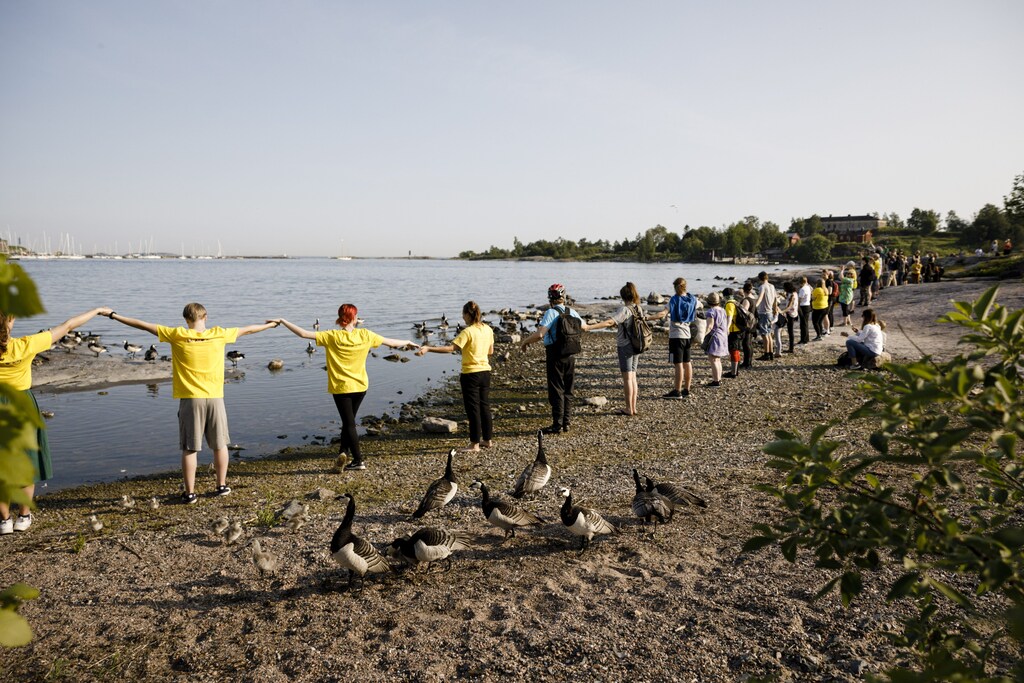 People clean the Baltic Sea coastline during the World Environment Day Clean-Up event in Kaivopuisto Park in Helsinki, Finland