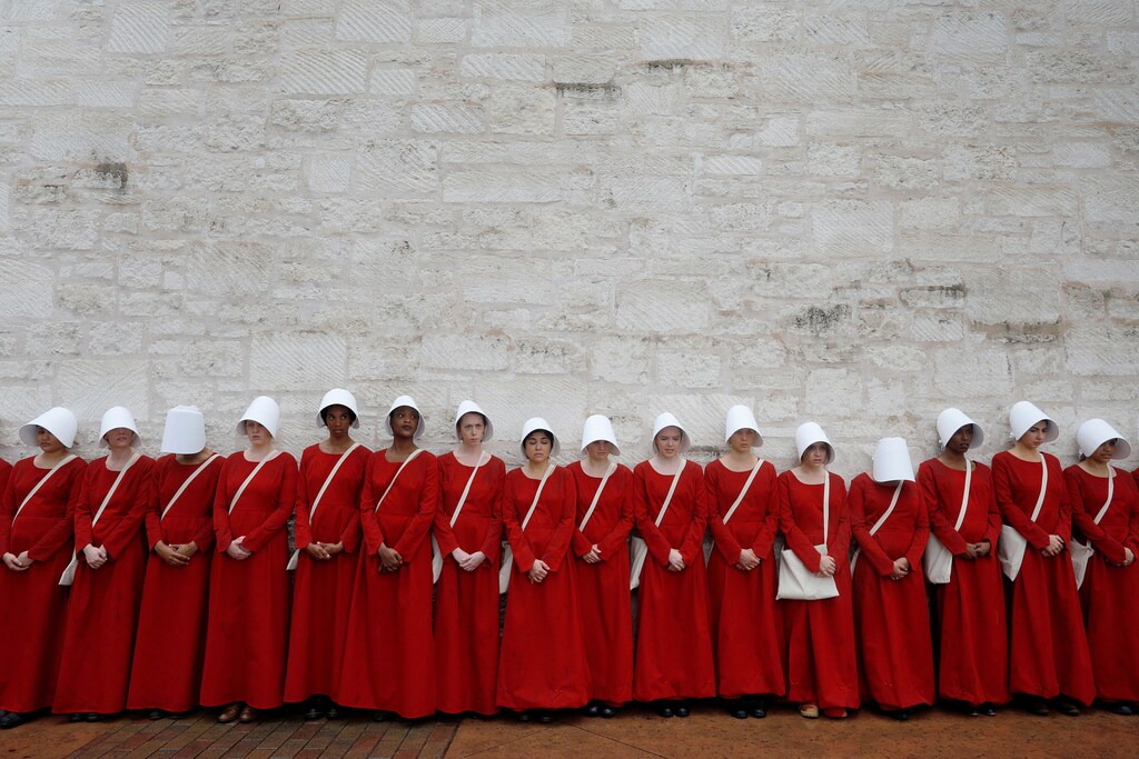 Women dressed as handmaids promoting the Hulu original series "The Handmaid's Tale" stand along a public street during the South by Southwest (SXSW) Music Film Interactive Festival 2017 in Austin, Texas, U.S., March 11, 2017. REUTERS/Brian Snyder - RTX30ML9