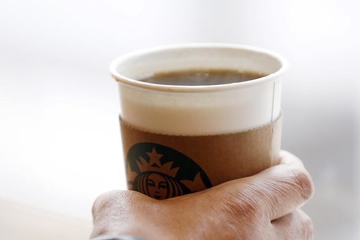A man holds an Americano at a Starbucks coffee shop in Seoul, South Korea, March 7, 2016. Picture taken March 7, 2016. REUTERS/Kim Hong-Ji