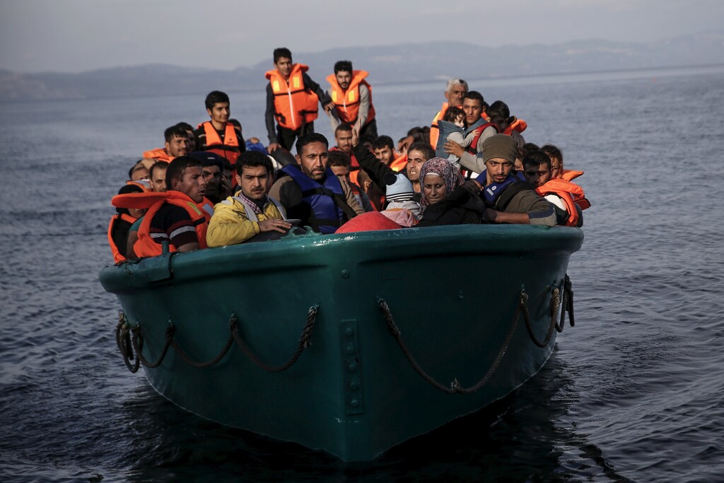 Refugees and migrants arrive on an overcrowded boat on the Greek island of Lesbos, November 10, 2015. Since the start of the year, over 590,000 people have crossed into Greece, the frontline of a massive westward population shift from war-ravaged Syria and beyond. REUTERS/Alkis Konstantinidis - GF20000053323