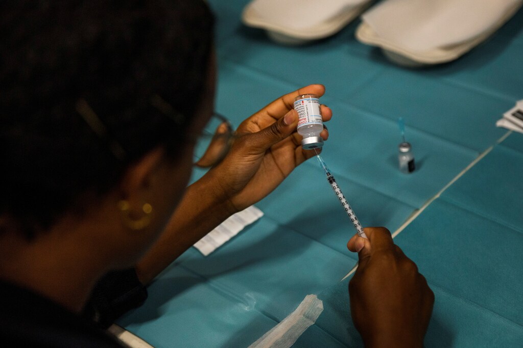 A health worker prepares a dose of the coronavirus disease (COVID-19) vaccine at a pop-up vaccination center set-up in Faelledparken
