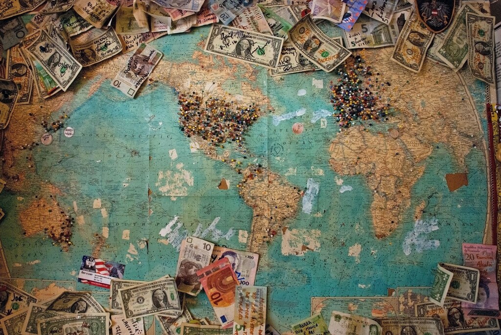 Multiple paper currencies on a world map