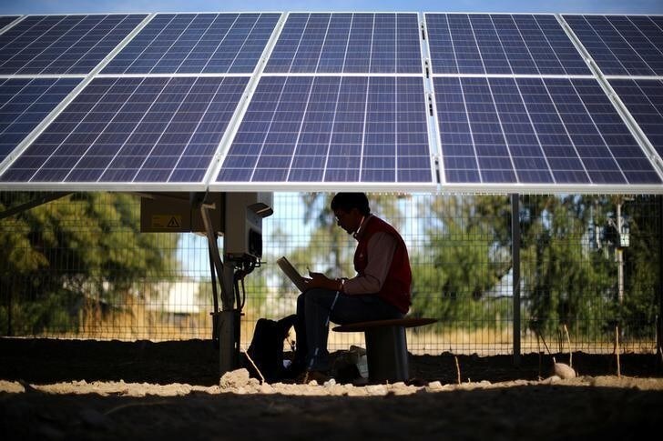 An engineer works under solar panels at a solar plant near Santiago, Chile May 5, 2017. Picture taken May 5, 2017. REUTERS/Ivan Alvarado