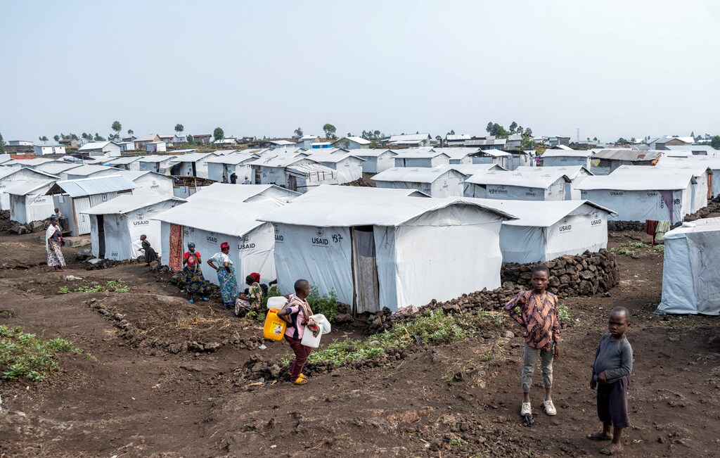 Children stand at the Muja camp for the internally displaced persons amid an outbreak of Mpox in DR Congo.