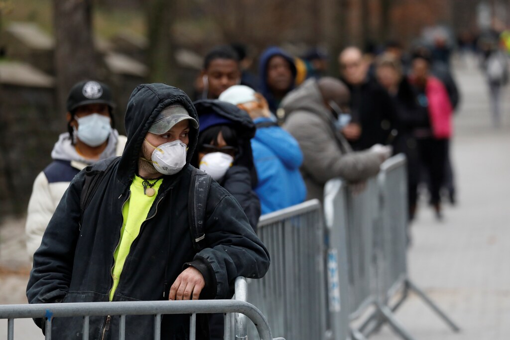 People queue to enter a tent erected to test for the coronavirus disease (COVID-19) at the Brooklyn Hospital Center in Brooklyn, New York City, U.S., March 19, 2020.