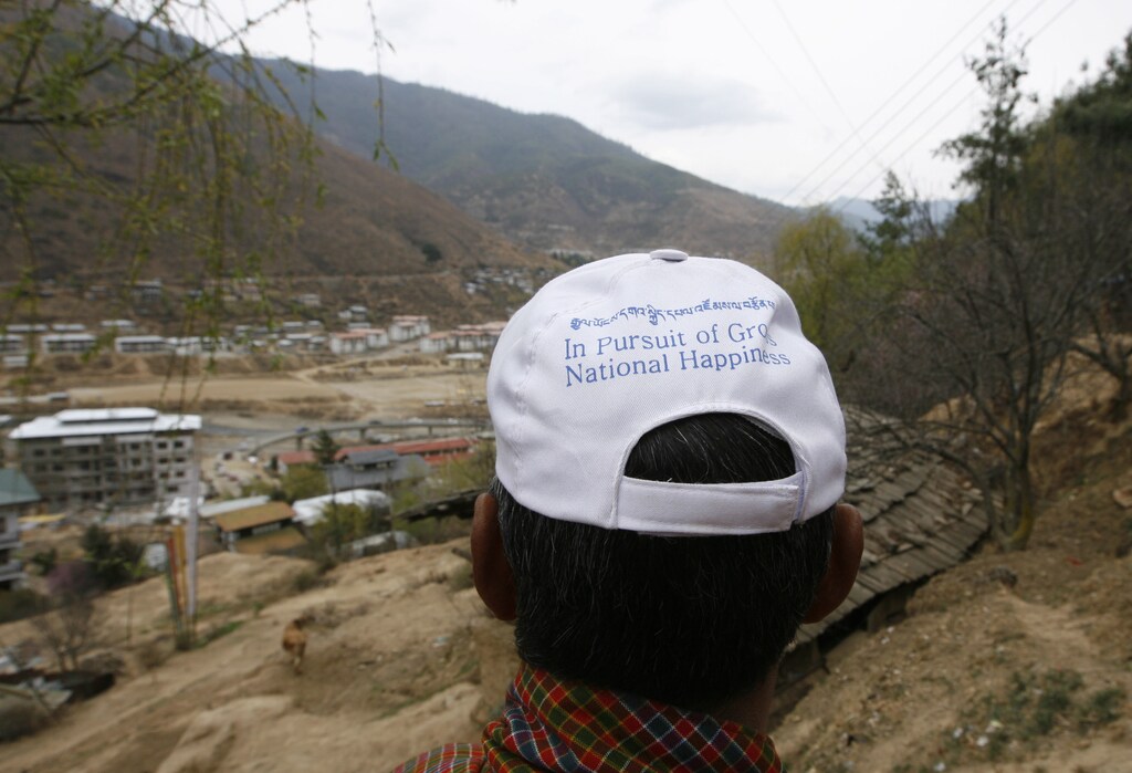 A member of the new party 'Druk Phuensum Tshogpa' (DPT) wears a cap with the motto of the party, 'In pursuit of Gross National Happiness' during their election campaign in the capital Thimpu March 20, 2008. Bhutan will go to the polls for the first time on March 24. REUTERS/Desmond Boylan (BHUTAN) - GM1E43L069P01