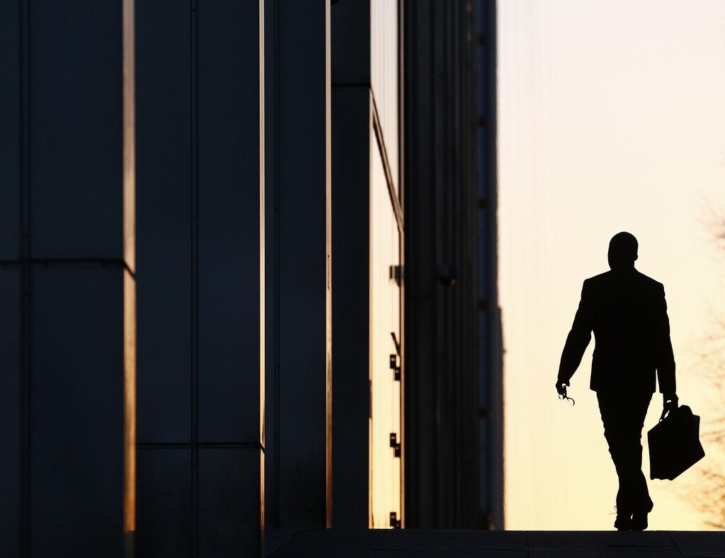 A worker arrives at his office in the Canary Wharf business district in London February 26, 2014. London's financial services sector created 25 percent more jobs in February than a year ago, new data has shown, indicating the industry may be recovering from the restructuring and redundancies prompted by the financial crisis. After a strong January, the City hiring market showed no signs of slowing down last month, with 3,220 new jobs created, compared with 2,575 added in February 2013, according to financial services recruiter Astbury Marsden. The data suggests London's banks and financial services companies are returning to growth after slashing thousands of jobs in the face of a lengthy recession and a series of industry scandals that followed the financial crisis.