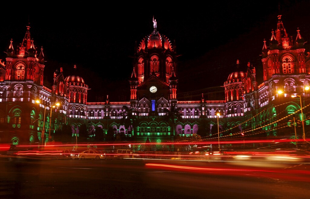 Traffic moves in front of the Chhatrapati Shivaji Terminus railway station as it is illuminated with the colours of the Indian flag in lieu of Independence Day in Mumbai, India, August 15, 2015.
