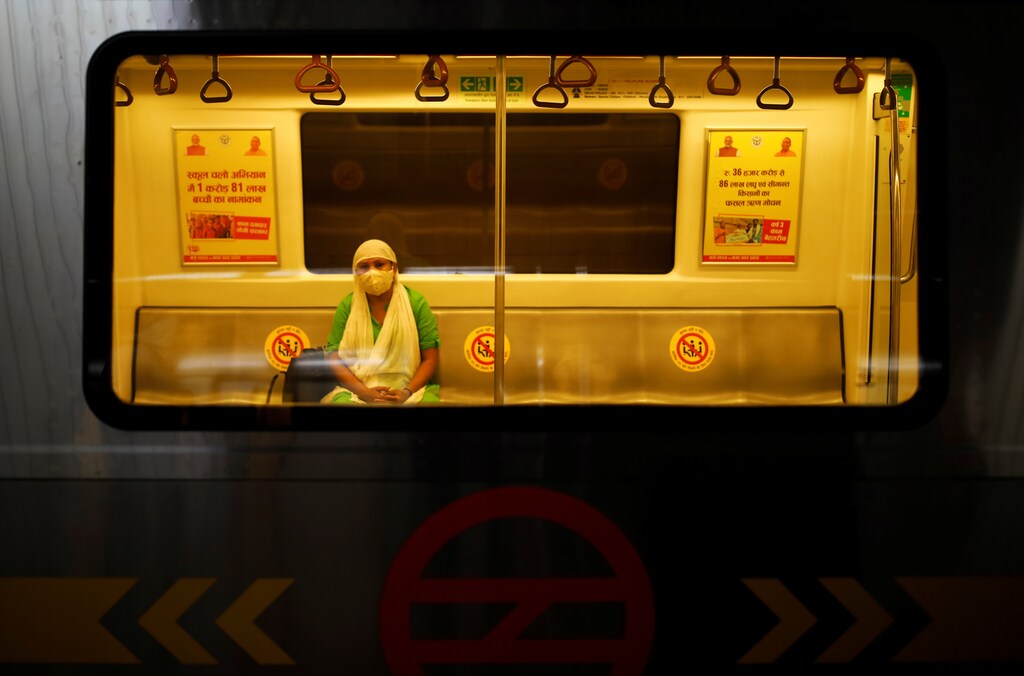 A woman wearing a face mask travels inside a Delhi metro train, on the first day of the restart of their operations, amidst the spread of coronavirus disease (COVID-19), in New Delhi, India, September 7, 2020. REUTERS/Adnan Abidi - RC2ITI9WIHTH