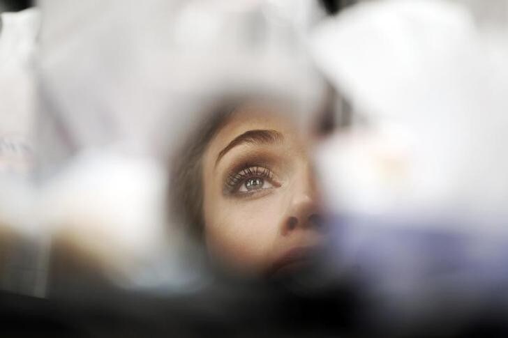 A model is reflected in a small mirror as she gets made up during Cibeles Madrid Fashion Week September 19, 2011. REUTERS/Susana Vera (SPAIN - Tags: FASHION)