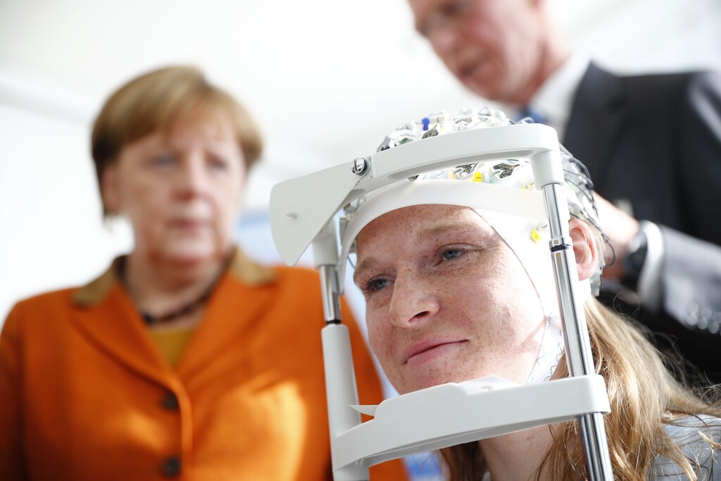 German chancellor Angela Merkel visits the section for measuring brainwaves at the new research center for dementia diseases, DZNE, at the university hospital in Bonn, Germany