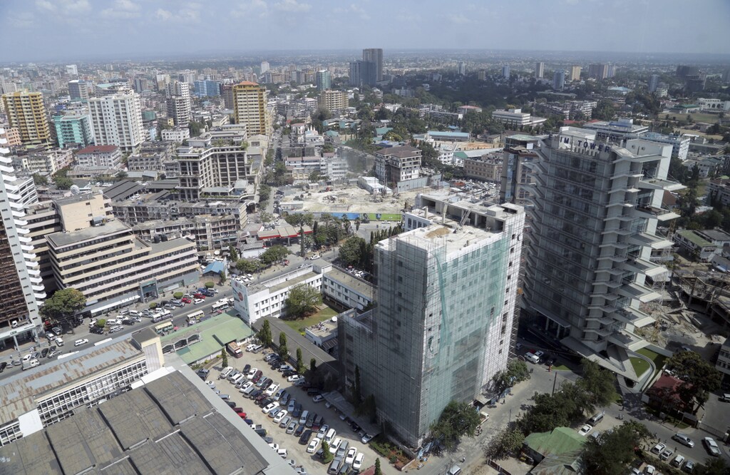 A general picture shows the skyline of Tanzania's port cty of Dar es Salaam, July 12, 2013. Tanzania's commercial capital looks like a boom town even before cash rolls in from gas discoveries that in the next few years could make the east African nation a major energy exporter. Glass-clad tower blocks pierce Dar es Salaam's sky-line and more are emerging from noisy building sites. Billboards advertise high-definition televisions and other electronics to a new middle class, who crowd brand new shopping malls. REUTERS/Andrew Emmanuel (TANZANIA - Tags: SOCIETY BUSINESS ENERGY CITYSCAPE) - RTX11L78