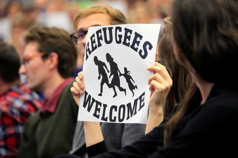 Students display placards during the speech of Norbert Hofer, Joint Acting President of Austria and Third President of the National Council, during a panel discussion on "Can Europes politicians solve its migration crisis?" at Geneva's graduate institute, in Geneva, Switzerland, October 20, 2016. REUTERS/Pierre Albouy