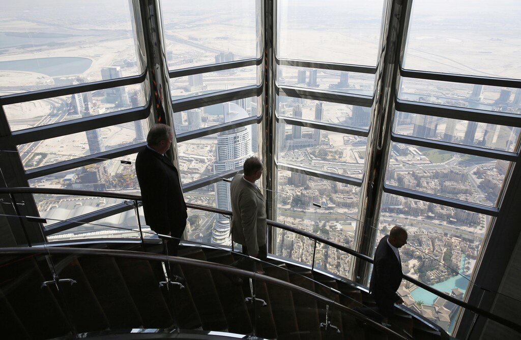 Businessmen walk down the stairs at the 123rd floor of the Burj Khalifa, the tallest building in the world, in Dubai.