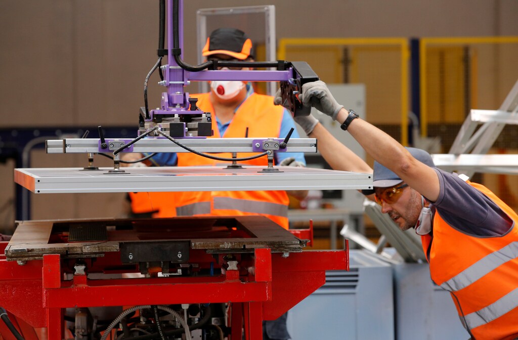 Employees work at Veolias solar panel recycling plant in Rousset, France, June 25, 2018. At the plant, photovoltaic panels are dissembled and their constituent parts such as glass, aluminium, silicon and plastics are recycled. REUTERS/Jean-Paul Pelissier - RC1AF492F800