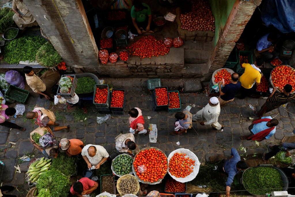 People shop at a crowded wholesale vegetable market after authorities eased coronavirus restrictions, following a drop in the coronavirus disease (COVID-19) cases, in the old quarters of Delhi, India, June 23, 2021. REUTERS/Adnan Abidi TPX IMAGES OF THE DAY - RC206O9SUYMF