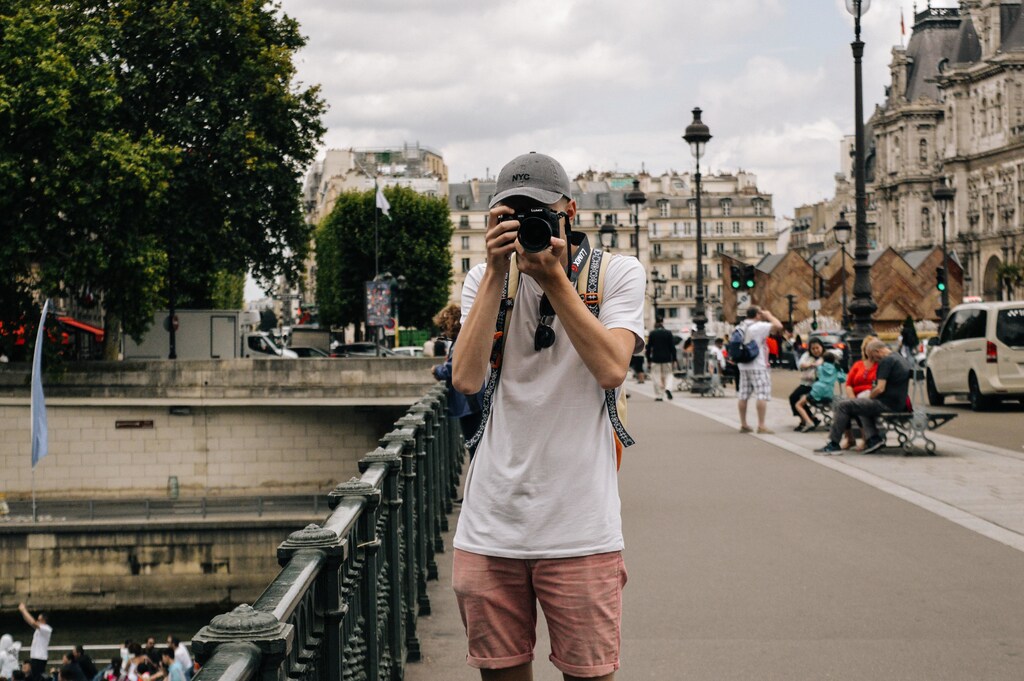 A tourist pointing a camera at the photographer.