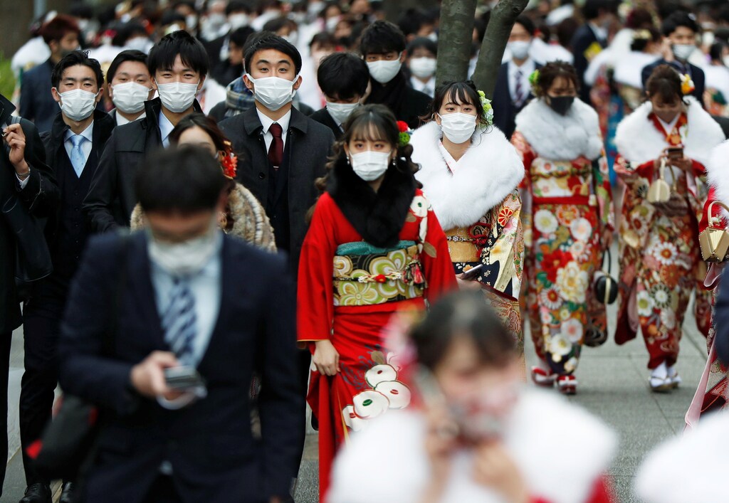 Youth including Kimono-clad women wearing protective face masks attend their Coming of Age Day celebration ceremony at Yokohama Arena after the government declared the second state of emergency for the capital and some prefectures, amid the coronavirus disease (COVID-19) outbreak, in Yokohama, Japan January 11, 2021. REUTERS/Issei Kato - RC2L5L9X2KNT