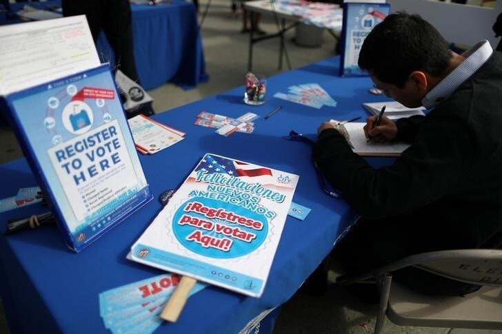 An immigrant signs up to vote in the upcoming midterm elections after participating in a naturalization ceremony to become a new U.S. citizen in Los Angeles, California, U.S. March 20, 2018. REUTERS/Lucy Nicholson