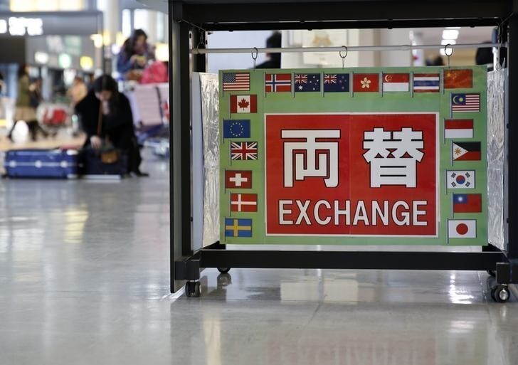 The word 'Echange' in Japanese surrounded with various national flags is seen at an exchage office at Narita International airport, near Tokyo, Japan, March 25, 2016. The dollar was on track on Friday for a weekly gain of over 1 percent against a basket of currencies after a chorus of U.S. Federal Reserve officials signalled more interest rate increases than the market had been pricing in. REUTERS/Yuya Shino