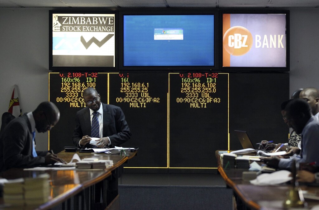 Stockbrokers trade on the floor of the Zimbabwe Stock Exchange in Harare June 6, 2014: The new Africa Credit Rating Agency (AfCRA) could help eliminate the African premium